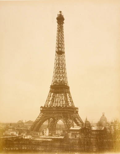 La Tour Eiffel quasiment achevée. Il manque l'antenne, 22 mars 89. Au second plan, les bâtiments de l'Exposition universelle. Au 1er plan la Seine - Louis-Emile Durandelle