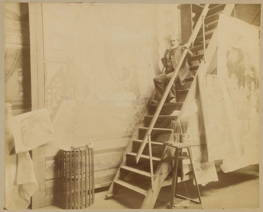 Charles Lameire photographié dans son atelier, assis sur l'escabeau, devant des cartons préparatoires, pour le Voeu de Louis XIII pour Fourvière et la Bataille de Nazareth pour Notre-Dame de Lorette notamment - D. Freuler